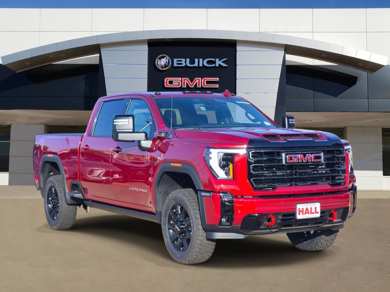 2026 GMC Sierra 2500 HD AT4 in Volcanic Red Tintcoat — front three-quarter view