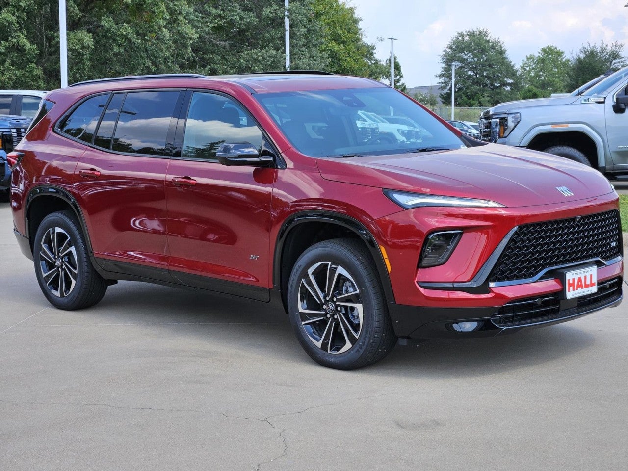 2026 Buick Enclave Sport Touring in Cherry Red Tintcoat — front three-quarter view