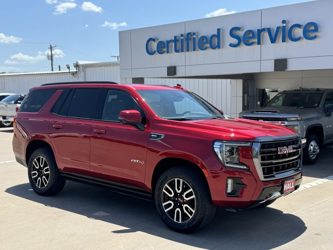 2024 GMC Yukon AT4 in Volcanic Red Tintcoat — front three-quarter view